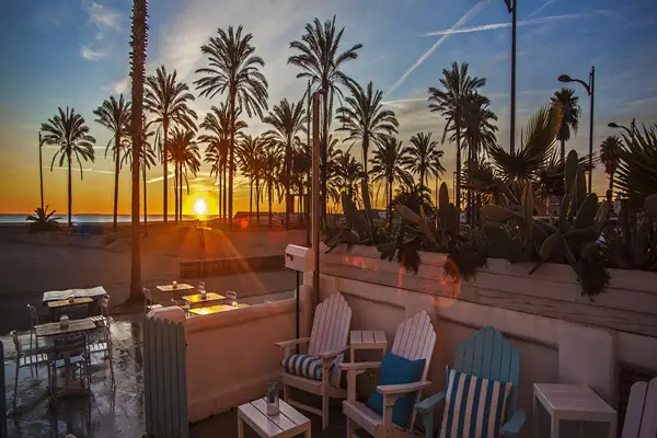 hotel in front of the beach with the sunset